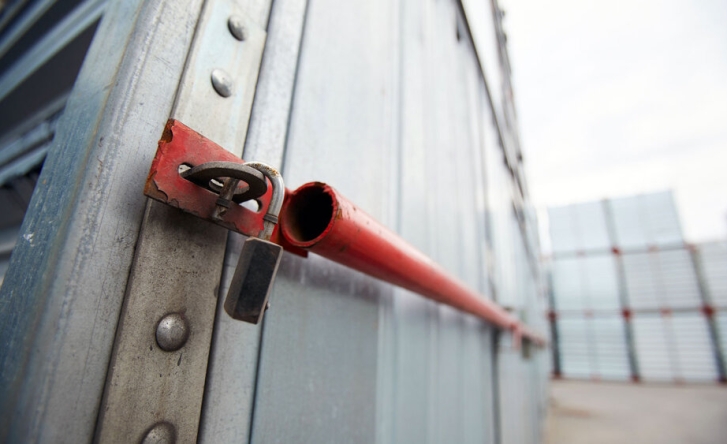 A close up of the padlock on a shipping container, it's unlocked.